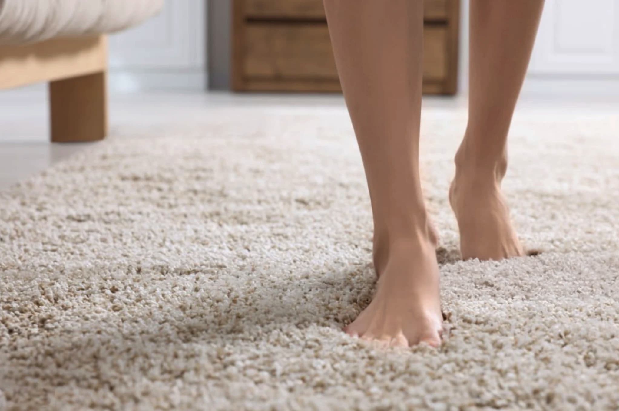 Bare feet enjoying soft, plush carpet